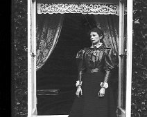 Gracie in drawing room window, Sedgeford Hall Original caption: Gracie (Grace Mary Hunt d. of Alfred Simon Hunt) in drawing room window