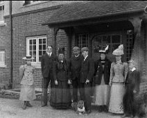 Group outside front door Original caption: Group outside front door