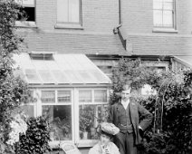 Lady and gent in garden Original caption: Lady and gent in garden