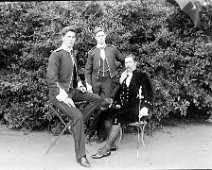 Father in court dress, Gilbert & Reggie in uniform Original caption: Father in court dress, Gilbert and Reggie in uniform