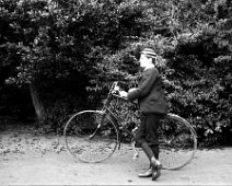 John with his bicycle Original caption: John with his bicycle