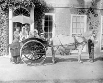 2 adults and 4 very young children in ponycart, Sedgeford Hall Original caption: 2 adults and 4 very young children in ponycart