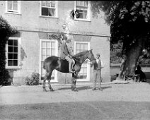 Ernest on Gypsy (with groom) at Sedgeford Hall Original caption: Young man on a horse (with groom)