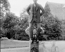 Reggie holding Gilbert on ladder, Sedgeford Hall Original caption: Reggie holding Gilberton ladder
