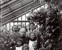 Family group in greenhouse, Sedgeford Hall in Sedgeford Hall greenhouse Original caption: Family group in greenhouse