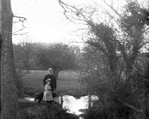 Mr. H. + girl by lake Sedgeford Park Original caption: Mr. H. + girl by lake