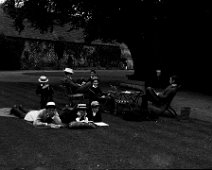 Family studying on lawn Sedgeford Hall Original caption: Family studying on lawn