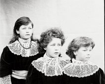 3 girls in red frocks Original caption: 3 girls in red frocks