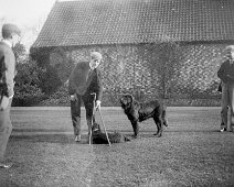 3 men & 2 dogs at Sedgeford Hall Original caption: 3 men and 2 dogs