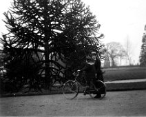 Boy in sailor suit on a bicycle with a girl Original caption: Boy in sailor suit on a bicycle with a girl