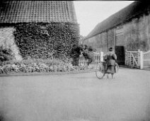 Woman with bicycle going through farm gate, Sedgeford Hall Original caption: Woman with bicycle going through farm gate