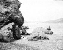 Man fishing in boat off shore Splat Cove (partially written in bottom LH corner) looking up estuary toward Salcombe Original caption: Man fishing in boat off shore