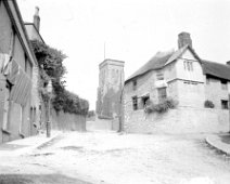 Holy Trinity church, Salcombe, Devon Original caption: A village scene