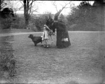 Lady with v. small child and dog Original caption: Lady with v. small child and dog